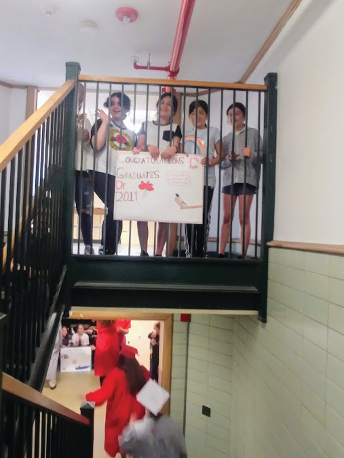 WAITING FOR A GLIMPSE: The students at Oaklawn Elementary School await the seniors’ visit, holding special congratulatory posters and signs as they pass by.